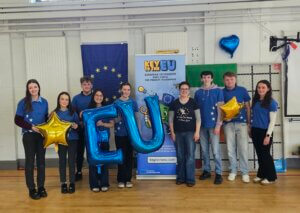 Group photo of the Key to the EU team holding balloons spelling out EU
